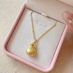 Golden Brushed Blessing Bag Pendant Necklace – Elegant Gold Jewelry